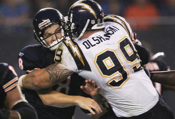 CHICAGO - AUGUST 18:   Igor Olshansky #99 of the San Diego Chargers hits Rex Grossman #8 of the Chicago Bears after a pass during a game on August 18, 2006 at Soldier Field in Chicago, Illinois.  (Photo by Jonathan Daniel/Getty Images)
