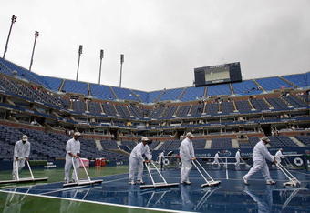 NEW YORK - AUGUST 29:  Court attendants dry the court during a rain delay at the U.S. Open at the USTA Billie Jean King National Tennis Center in Flushing Meadows Corona Park on August 29, 2006 in the Flushing neighborhood of the Queens borough of New York.  (Photo by Clive Brunskill/Getty Images)