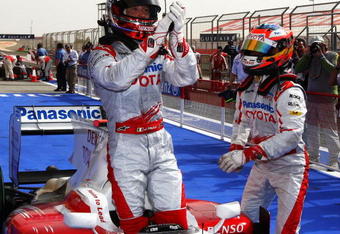 SAKHIR, BAHRAIN - APRIL 25:  Jarno Trulli (L) of Italy and Toyota celebrates with second placed team mate Timo Glock (R) of Germany and Toyota in parc ferme after taking pole position during qualifying for the Bahrain Formula One Grand Prix at the Bahrain International Circuit on April 25, 2009 in Sakhir, Bahrain.  (Photo by Clive Mason/Getty Images)