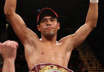 LAS VEGAS - DECEMBER 06:  (L-R) Juan Manuel Lopez of Puerto Rico celebrates his first round knockout of Sergio Medina of Argentina during their WBO junior featherweight title fight at the MGM Grand Garden Arena December 6, 2008 in Las Vegas, Nevada.  (Photo by Jed Jacobsohn/Getty Images)