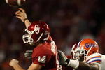 MIAMI - JANUARY 08:  Sam Bradford #14 of the Oklahoma Sooners gets pressured by Carlos Dunlap #8 of the Florida Gators as he throws during the FedEx BCS National Championship Game at Dolphin Stadium on January 8, 2009 in Miami, Florida.  (Photo by Donald Miralle/Getty Images)