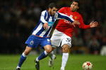 MANCHESTER, UNITED KINGDOM - APRIL 07:   Lisandro of FC Porto holds off the challenge of Carlos Tevez of Manchester United during the UEFA Champions League Quarter Final First Leg match between Manchester United and FC Porto at Old Trafford on April 7, 2009 in Manchester, England. (Photo by Alex Livesey/Getty Images)