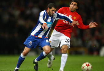 MANCHESTER, UNITED KINGDOM - APRIL 07:   Lisandro of FC Porto holds off the challenge of Carlos Tevez of Manchester United during the UEFA Champions League Quarter Final First Leg match between Manchester United and FC Porto at Old Trafford on April 7, 2009 in Manchester, England. (Photo by Alex Livesey/Getty Images)