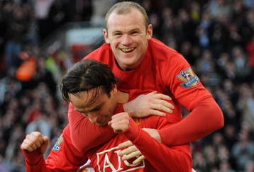 MANCHESTER, ENGLAND - APRIL 25:  Dimitar Berbatov of Manchester United is congratulated by team mate Wayne Rooney after scoring his team's fifth goal during the Barclays Premier League match between Manchester United and Tottenham Hotspur at Old Trafford on April 25, 2009 in Manchester, England.  (Photo by Shaun Botterill/Getty Images)