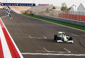 SAKHIR, BAHRAIN - APRIL 26:  Jenson Button of Great Britain and Brawn GP crosses the line to win the Bahrain Formula One Grand Prix at the Bahrain International Circuit on April 26, 2009 in Sakhir, Bahrain.  (Photo by Clive Mason/Getty Images)