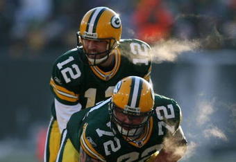 GREEN BAY, WI - DECEMBER 28: Aaron Rodgers #12 of the Green Bay Packers awaits the snap from George Foster #72 during a game against the Detroit Lions on December 28, 2008 at Lambeau Field in Green Bay, Wisconsin. The Packers defeated the Lions 31-21.  (Photo by Jonathan Daniel/Getty Images)