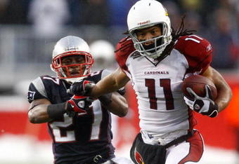 FOXBORO, MA - DECEMBER 21:  Ellis Hobbs #27 of the New England Patriots is unable to stop Larry Fitzgerald #11 of the Arizona Cardinals, who scored a touchdown on the run, at Gillette Stadium on December 21, 2008 in Foxboro, Massachusetts. The Patriots won 47-7. (Photo by Jim Rogash/Getty Images)