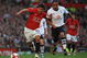 MANCHESTER, ENGLAND - APRIL 25:  Carlos Tevez of Manchester United holds off Benoit Assou-Ekotto of Tottenham Hotspur during the Barclays Premier League match between Manchester United and Tottenham Hotspur at Old Trafford on April 25, 2009 in Manchester, England.  (Photo by Shaun Botterill/Getty Images)