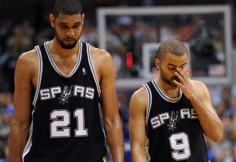 DALLAS - APRIL 25:  Forward Tim Duncan #21 and Tony Parker #9 of the San Antonio Spurs during a 99-90 loss against the Dallas Mavericks in Game Four of the Western Conference Quarterfinals during the 2009 NBA Playoffs at American Airlines Center on April 25, 2009 in Dallas, Texas. NOTE TO USER: User expressly acknowledges and agrees that, by downloading and or using this photograph, User is consenting to the terms and conditions of the Getty Images License Agreement.  (Photo by Ronald Martinez/Getty Images)