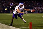 SAN DIEGO, CA - DECEMBER 23:  Runningback Ian Johnson #41 of the Boise State Broncos dives for the endzone pilon against the defense of Cornerback Rafael Priest #10 of TCU during the San Diego County Credit Union Poinsettia Bowl at Qualcomm Stadium on December 23, 2008 in San Diego, California. (Photo by Donald Miralle/Getty Images)