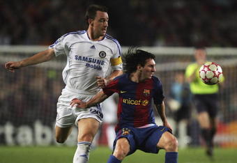 BARCELONA, SPAIN - OCTOBER 31:  Chelsea captain John Terry battles with Lionel Messi of Barcelona during the UEFA Champions League group A match between Barcelona and Chelsea at the Nou Camp stadium on October 31, 2006 in Barcelona, Spain.  (Photo by Mike Hewitt/Getty Images)
