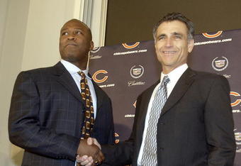 LIBERTYVILLE, IL - JANUARY 15:  Chicago Bears General Manager Jerry Angelo (R) congratulates former defensive coordinator for the St. Louis Rams, Lovie Smith (L), on his four year contract as head coach of the Chicago Bears at a media conference on January 15, 2004 in Libertyville, Illinois.  (Photo by Aynsley Floyd/Getty Images)