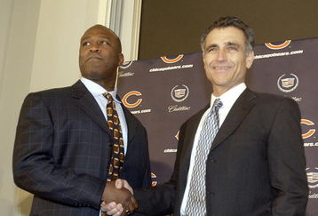 LIBERTYVILLE, IL - JANUARY 15:  Chicago Bears General Manager Jerry Angelo (R) congratulates former defensive coordinator for the St. Louis Rams, Lovie Smith (L), on his four year contract as head coach of the Chicago Bears at a media conference on January 15, 2004 in Libertyville, Illinois.  (Photo by Aynsley Floyd/Getty Images)