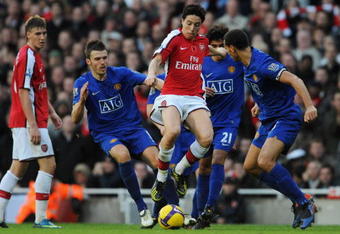 LONDON - NOVEMBER 08:  Samir Nasri of Arsenal takes on Michael Carrick, Rafael Da Silva and Rio Ferdinand of Manchester United during the Barclays Premier League match between Arsenal and Manchester United at the Emirates Stadium on November 8, 2008 in London, England.  (Photo by Shaun Botterill/Getty Images)