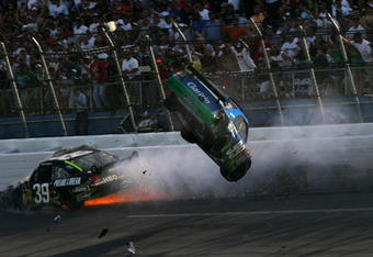 TALLADEGA, AL - APRIL 26:  Carl Edwards, driver of the #99 Claritin Ford goes airborne as Ryan Newman, driver of the #34 Stewart-Haas Racing Chevrolet hits the wall at the end of the NASCAR Sprint Cup Series Aaron's 499 at Talladega Superspeedway on April 26, 2009 in Talladega, Alabama.  (Photo by Todd Warshaw/Getty Images)