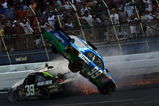 TALLADEGA, AL - APRIL 26:  Carl Edwards, driver of the #99 Claritin Ford goes airborne as Ryan Newman, driver of the #34 Stewart-Haas Racing Chevrolet hits the wall at the end of the NASCAR Sprint Cup Series Aaron's 499 at Talladega Superspeedway on April 26, 2009 in Talladega, Alabama.  (Photo by Todd Warshaw/Getty Images)
