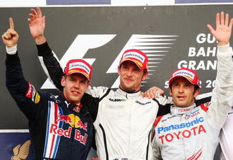 SAKHIR, BAHRAIN - APRIL 26:  Race winner Jenson Button (C) of Great Britain and Brawn GP, second placed Sebastian Vettel (L) of Germany and Red Bull Racing and third placed Jarno Trulli (R) of Italy and Toyota celebrate on the podium following the Bahrain Formula One Grand Prix at the Bahrain International Circuit on April 26, 2009 in Sakhir, Bahrain.  (Photo by Clive Mason/Getty Images)