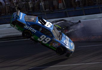 TALLADEGA, AL - APRIL 26:  Carl Edwards, driver of the #99 Claritin Ford goes airborne as Ryan Newman, driver of the #34 Stewart-Haas Racing Chevrolet hits the wall at the end of the NASCAR Sprint Cup Series Aaron's 499 at Talladega Superspeedway on April 26, 2009 in Talladega, Alabama.  (Photo by Todd Warshaw/Getty Images)