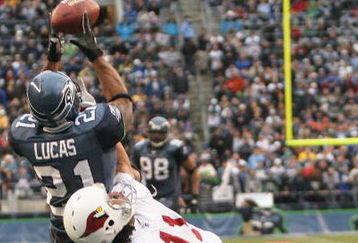 SEATTLE - DECEMBER 26:  Ken Lucas #21 of the Seattle Seahawks intercepts this pass in the end zone against Wide Receiver Larry Fitzgerald #11 of the Arizona Cardinals at Qwest Field December 26, 2004 in Seattle, Washington. (Photo by Otto Greule Jr/Getty Images)