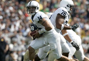 SOUTH BEND, IN - SEPTEMBER 09:  Anthony Morelli #14 of the Penn State Nittany Lions turns to hand off in front of teammate Gerald Cadogan #76 during a game against the Notre Dame Fighting Irish on September 9, 2006 at Notre Dame Stadium in South Bend, Indiana. Notre Dame won the game 41-17.  (Photo by Gregory Shamus/Getty Images)