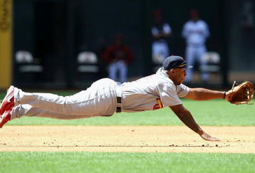 PHOENIX - APRIL 15:  Infielder Joe Thurston of the St. Louis Cardinals makes a diving attempt at a single hit by the Arizona Diamondbacks during the game at Chase Field April 15, 2009 in Phoenix, Arizona. All Major League Baseball players are wearing #42 in honor of Jackie Robinson day.  (Photo by Christian Petersen/Getty Images)