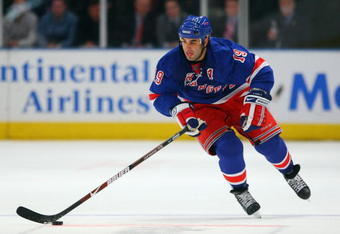 NEW YORK - DECEMBER 3:  Scott Gomez #19 of the New York Rangers skates with the puck during the game against the Pittsburgh Penguins on December 3, 2008 at Madison Square Garden in New York City. (Photo by Bruce Bennett/Getty Images)