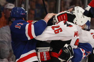 NEW YORK - APRIL 26:  Brandon Dubinsky #17 of the New York Rangers goes up against Shaone Morrisonn #26 of the Washington Capitals during Game Six of the Eastern Conference Quarterfinal Round of the 2009 NHL Stanley Cup Playoffs at Madison Square Garden on April 26, 2009 in New York, New York. The Capitals defeated the Rangers 5-3.  (Photo by Bruce Bennett/Getty Images)