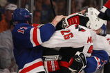 NEW YORK - APRIL 26:  Brandon Dubinsky #17 of the New York Rangers goes up against Shaone Morrisonn #26 of the Washington Capitals during Game Six of the Eastern Conference Quarterfinal Round of the 2009 NHL Stanley Cup Playoffs at Madison Square Garden on April 26, 2009 in New York, New York. The Capitals defeated the Rangers 5-3.  (Photo by Bruce Bennett/Getty Images)
