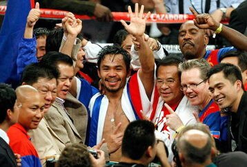 LAS VEGAS - DECEMBER 06:  Manny Pacquiao of the Philippines and his team celebrate his victory over Oscar De La Hoya in their welterweight bout at the MGM Grand Garden Arena December 6, 2008 in Las Vegas, Nevada.  (Photo by Ethan Miller/Getty Images)
