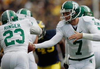 ANN ARBOR, MI - OCTOBER 25:  Brian Hoyer #7 of the Michigan State Spartans hands the ball off to teammate Javon Ringer #23 during the game against the Michigan Wolverines on October 25, 2008 at Michigan Stadium in Ann Arbor, Michigan. Michigan State won the game 35-21. (Photo by Gregory Shamus/Getty Images)