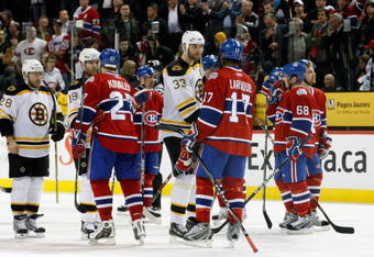 MONTREAL- APRIL 22:  Alexei Kovalev #27 and Georges Laraque #17 of the Montreal Canadiens shake hands with Stephane Yelle #18 and Zdeno Chara #33 of the Boston Bruins after Game Four of the Eastern Conference Quarterfinals of the 2009 Stanley Cup Playoffs at the Bell Centre on April 22, 2009 in Montreal, Quebec, Canada.  The Bruins defeated the Canadiens 4-1 winning the series 4-0.  (Photo by Richard Wolowicz/Getty Images)