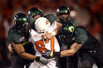 SAN DIEGO, CA - DECEMBER 30:   Tight End Brandon Pettigrew #87 of the Oklahoma State University Cowboys is tackled by the defense of the University of Oregon Ducks during the Ducks 42-31 win over the Cowboys in the Pacific Life Holiday Bowl at Qualcomm Stadium on December 30, 2008 in San Diego, California. (Photo by Donald Miralle/Getty Images)