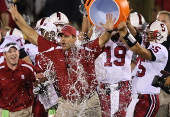 LOS ANGELES - OCTOBER 6:  Alex Loukas #15 celebrates with head coach Jim Harbaugh of the Stanford University Cardinal after defeating the USC Trojans 24-23 at the Los Angeles Memorial Coliseum October 6, 2007 in Los Angeles, California.  (Photo by Lisa Blumenfeld/Getty Images)