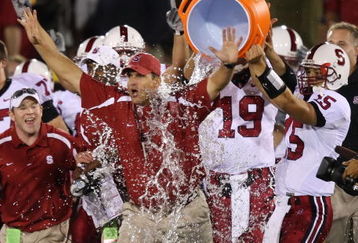 LOS ANGELES - OCTOBER 6:  Alex Loukas #15 celebrates with head coach Jim Harbaugh of the Stanford University Cardinal after defeating the USC Trojans 24-23 at the Los Angeles Memorial Coliseum October 6, 2007 in Los Angeles, California.  (Photo by Lisa Blumenfeld/Getty Images)