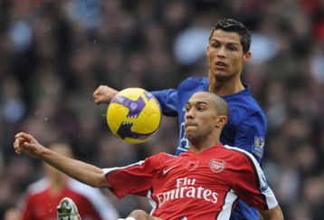 LONDON - NOVEMBER 08:  Gael Clichy of Arsenal clears the ball from Cristiano Ronaldo of Manchester United during the Barclays Premier League match between Arsenal and Manchester United at the Emirates Stadium on November 8, 2008 in London, England.  (Photo by Shaun Botterill/Getty Images)