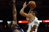 SAN ANTONIO - APRIL 28:  Forward Tim Duncan #21 of the San Antonio Spurs takes a shot against Erick Dampier #25 of the Dallas Mavericks in Game Five of the Western Conference Quarterfinals during the 2009 NBA Playoffs at AT&T Center on April 28, 2009 in San Antonio, Texas. NOTE TO USER: User expressly acknowledges and agrees that, by downloading and or using this photograph, User is consenting to the terms and conditions of the Getty Images License Agreement.  (Photo by Ronald Martinez/Getty Images)