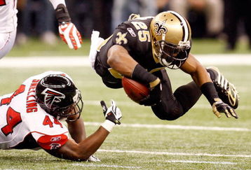 NEW ORLEANS - DECEMBER 07:  Reggie Bush #25 of the New Orleans Saints is tripped by Jason Snelling #44 of the Atlanta Falcons on December 7, 2008 at the Superdome in New Orleans, Louisiana.  (Photo by Chris Graythen/Getty Images)