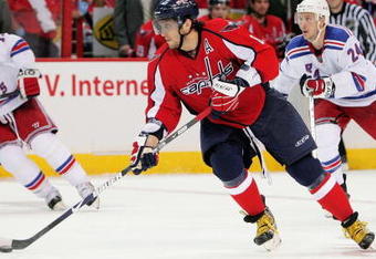 WASHINGTON - APRIL 24:  Alex Ovechkin #8 of the Washington Capitals skates the puck past Ryan Callahan #24 of the New York Rangers during Game Five of the Eastern Conference Quarterfinal Round of the 2009 Stanley Cup Playoffs on April 24, 2009 at the Verizon Center in Washington,  DC.  (Photo by Len Redkoles/Getty Images)