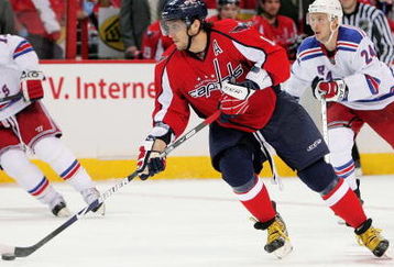 WASHINGTON - APRIL 24:  Alex Ovechkin #8 of the Washington Capitals skates the puck past Ryan Callahan #24 of the New York Rangers during Game Five of the Eastern Conference Quarterfinal Round of the 2009 Stanley Cup Playoffs on April 24, 2009 at the Verizon Center in Washington,  DC.  (Photo by Len Redkoles/Getty Images)