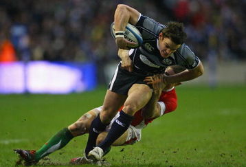 EDINBURGH, UNITED KINGDOM - FEBRUARY 08:  Hugo Southwell of Scotland holds off a challenge from Shane Williams of Wales on his way to scoring a try during the RBS Six Nations Championship match between Scotland and Wales at Murrayfield Stadium on February 8, 2009 in Edinburgh, Scotland.  (Photo by Alex Livesey/Getty Images)