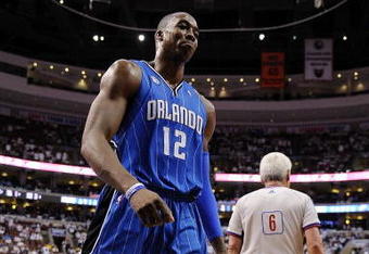 PHILADELPHIA - APRIL 24:  Dwight Howard #12 of the Orlando Magic walks to the bench for a timeout during Game Three against the Philadelphia 76ers of the Eastern Conference Quarterfinals during the 2009 NBA Playoffs at the Wachovia Center on April 24, 2009 in Philadelphia, Pennsylvania. The 76ers won 96-94.  NOTE TO USER: User expressly acknowledges and agrees that, by downloading and/or using this Photograph, user is consenting to the terms and conditions of the Getty Images License Agreement.  (Photo by Jeff Zelevansky/Getty Images)