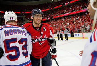 WASHINGTON - APRIL 28:  Alex Ovechkin #8 of the Washington Capitals smiles as he shakes the hand of Derek Morris #53 of the New York Rangers after defeating him during Game Seven of the Eastern Conference Quarterfinal Round of the 2009 Stanley Cup Playoffs on April 28, 2009 at the Verizon Center in Washington,  DC.  (Photo by Len Redkoles/Getty Images)