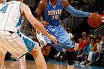 NEW ORLEANS - APRIL 27:  Carmelo Anthony #15 of the Denver Nuggets drives the ball around Sean Marks #4 of the New Orleans Hornets in Game Four of the Western Conference Quarterfinals during the 2009 NBA Playoffs at New Orleans Arena on April 27, 2009 in New Orleans, Louisiana.  The Nuggets defeated the Hornets 121-63.   NOTE TO USER: User expressly acknowledges and agrees that, by downloading and or using this photograph, User is consenting to the terms and conditions of the Getty Images License Agreement.  (Photo by Chris Graythen/Getty Images)