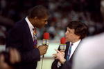 17 May 1992: NBC sportscaster Marv Albert and Earvin Magic Johnson talk during a game between the Chicago Bulls and the New York Knicks at the United Center in Chicago, Illinois.