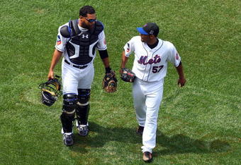 NEW YORK - APRIL 29:  Johan Santana #57 of the New York Mets talks with teammate Ramon Castro #11 after an inning against the Florida Marlins on April 29, 2009 at Citi Field in the Flushing neighborhood of the Queens borough of New York City. The Marlins defeated the Mets 4-3.  (Photo by Jim McIsaac/Getty Images)
