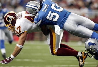 DETROIT , MI - OCTOBER 26:  Chris Cooley #47 of the Washington Redskins gets tackled by Ernie Sims #50 of the  Detroit Lions in the first half of the game on October 26, 2008 at Ford Field in Detroit, Michigan.  (Photo by Domenic Centofanti/Getty Images)
