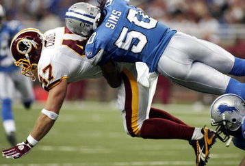 DETROIT , MI - OCTOBER 26:  Chris Cooley #47 of the Washington Redskins gets tackled by Ernie Sims #50 of the  Detroit Lions in the first half of the game on October 26, 2008 at Ford Field in Detroit, Michigan.  (Photo by Domenic Centofanti/Getty Images)