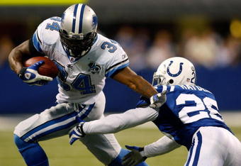 INDIANAPOLIS - DECEMBER 14:  Kevin Smith #34 of the Detroit Lions avoids a tackle by Kelvin Hayden #26 of the Indianapolis Colts on December 14, 2008 at Lucas Oil Stadium in Indianapolis, Indiana.  The Colts defeated the Lions 31-21.  (Photo by Chris Graythen/Getty Images)