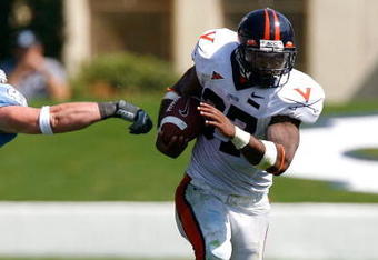 CHAPEL HILL, NC - SEPTEMBER 15:  Tailback Cedric Peerman #37 of the Virginia Cavaliers rushes upfield past linebacker Mark Paschal #41 of the North Carolina Tar Heels during the Cavaliers 22-20 win in their Atlantic Coast Conference football game at Kenan Stadium September 15, 2007 in Chapel Hill, North Carolina.  (Photo by Kevin C. Cox/Getty Images)