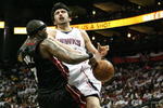 ATLANTA - APRIL 29:  Jermaine O'Neal #7 of the Miami Heat fouls Zaza Pachulia #27 of the Atlanta Hawks during Game Five of the Eastern Conference Quarterfinals at Philips Arena on April 29, 2009 in Atlanta, Georgia. The Hawks defeated the Heat 106-91. NOTE TO USER: User expressly acknowledges and agrees that, by downloading and/or using this Photograph, user is consenting to the terms and conditions of the Getty Images License Agreement.  (Photo by Doug Benc/Getty Images)